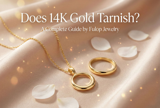 Luxury banner showing a 14K gold engagement ring on soft champagne fabric, used for a blog about whether 14K gold tarnishes.